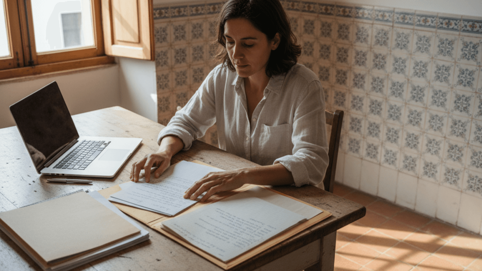 Freelancer reviewing invoicing-readiness notes and documents before starting self-employed work in Portugal.